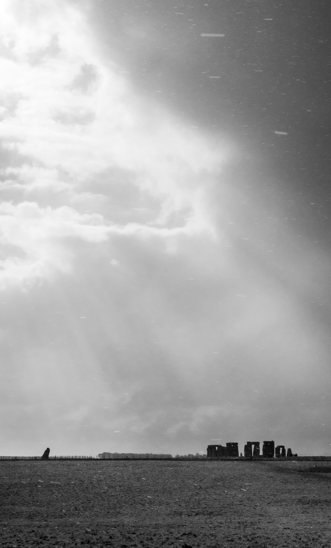 High contrast black and white photo of Stonehenge in a snowstorm